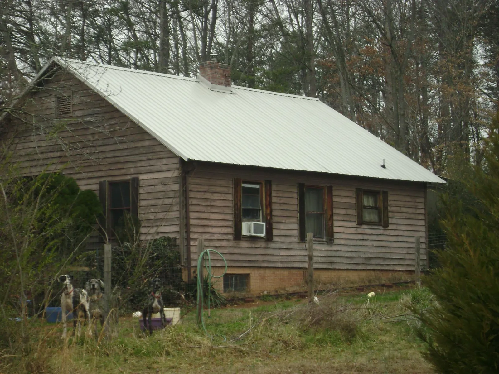 White metal roof on an old wood sided farmhouse, from a Metal Roof Installation job in Stantonsburg